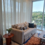 living room with couch large window curtains